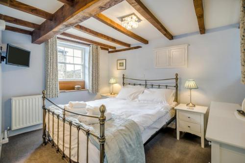 a bedroom with a bed and a window at 2 Bed in Askrigg oc-ds778 in Askrigg