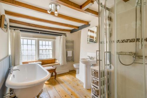 a bathroom with a tub and a sink and a shower at 2 Bed in Askrigg oc-ds778 in Askrigg