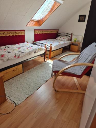 a dorm room with two beds and a skylight at Naplopó-lak in Ábrahámhegy