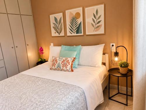 a bedroom with a white bed with two pillows at Home Volos in Volos