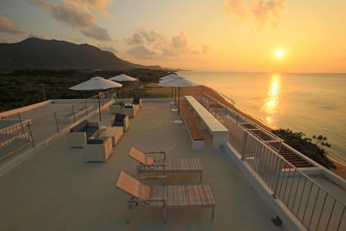 a row of chairs and tables on a cruise ship at sunset at Seven Colors Ishigakijima in Ishigaki Island