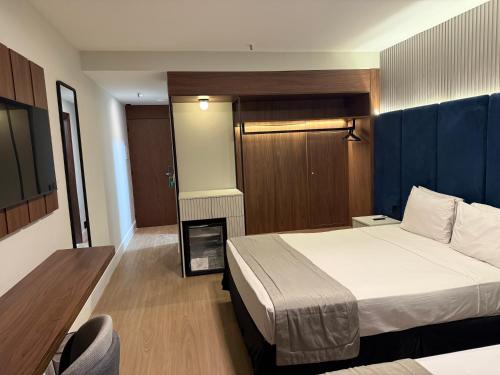 a bedroom with a bed and a room with a fireplace at Américas Benidorm Hotel in Rio de Janeiro