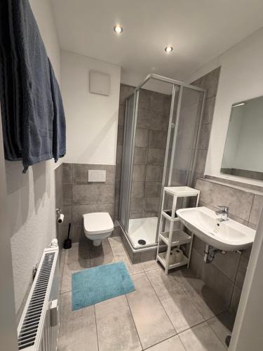a bathroom with a shower and a toilet and a sink at Felix Appartment H1a in Koblenz
