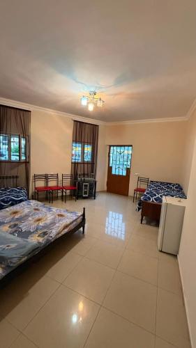 a large room with two beds and tables in it at Joni Mot in Goris