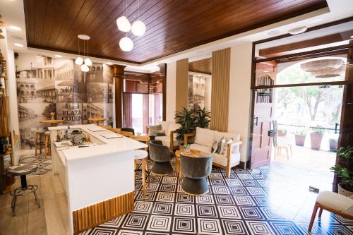 a lobby with a bar with chairs and tables at Hotel Plaza Colon - Granada Nicaragua in Granada