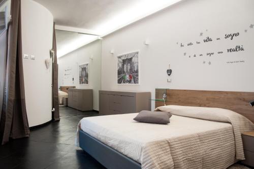 a bedroom with two beds and a white wall at 29 by Le Suite in Lugo