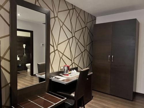 a room with a mirror and a table with a mirror at Hotel Infinity San Pietro in Rome