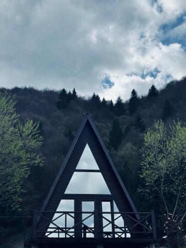 a triangular roof of a house in the middle of a forest at Котедж Shalet in Kolochava