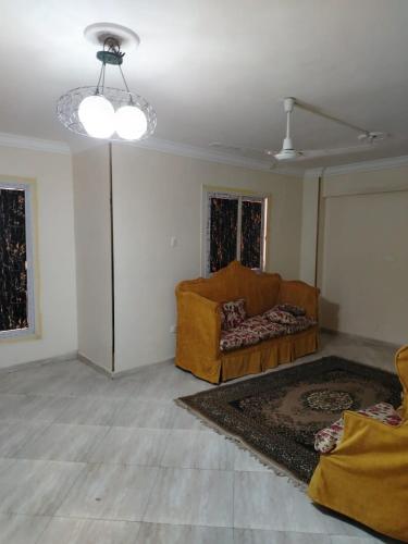 a living room with a couch and a ceiling at العبور الحى التاسع in Obour