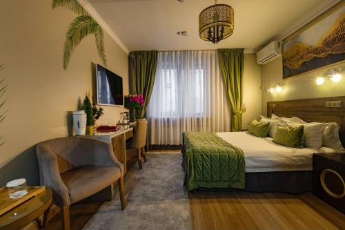 a hotel room with a bed and a desk at Luna Hotel Astana in Astana