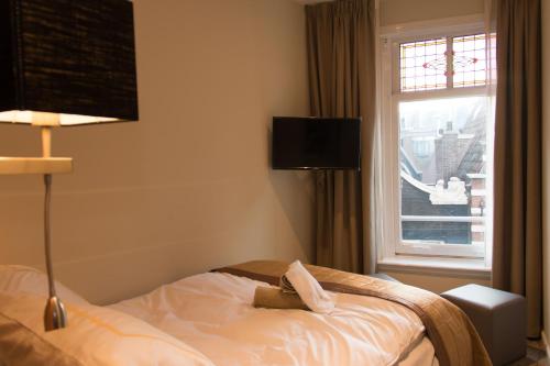 a hotel room with a bed with a window at Royal Plaza Hotel Amsterdam in Amsterdam