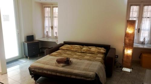 a bedroom with a bed in a room with windows at Almes' home in Bosisio Parini
