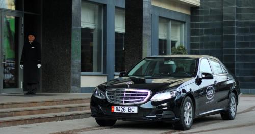 a small black car parked in front of a building at Orion Hotel Bishkek in Bishkek