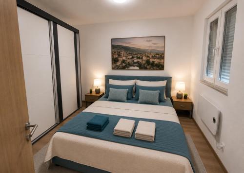 a bedroom with a large bed with two pillows at Apartman Trifko in Pale