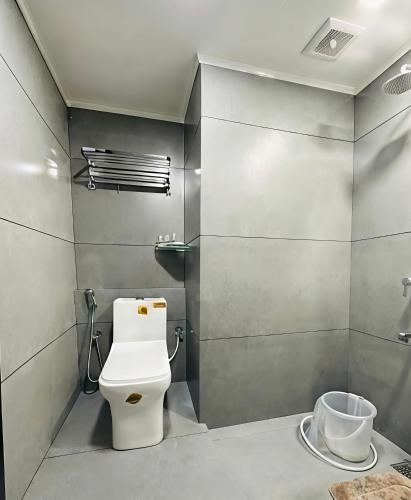 a bathroom with a toilet and a sink at Hotel Golden Heights International in Ernakulam