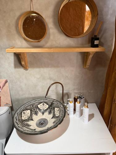 a bathroom with a sink and two mirrors at Nilamane in Asilah