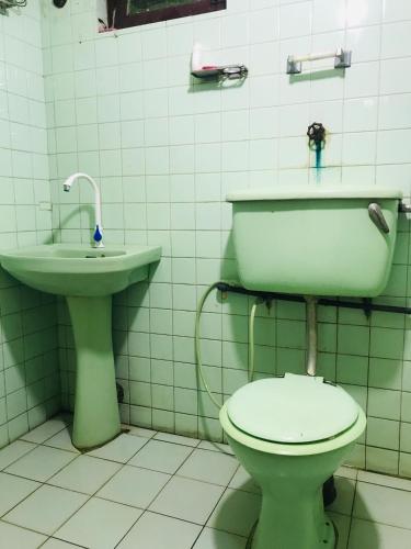 a bathroom with a toilet and a sink at Sapphire Homestay in Palle Deltota