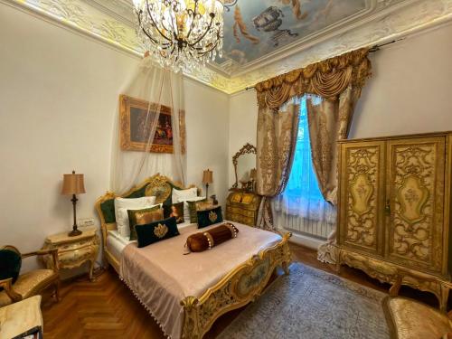 a bedroom with a bed and a chandelier at Conacul Coroanei Luxury Boutique in Bucharest