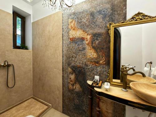 a bathroom with a large mirror and a sink at Conacul Coroanei Luxury Boutique in Bucharest