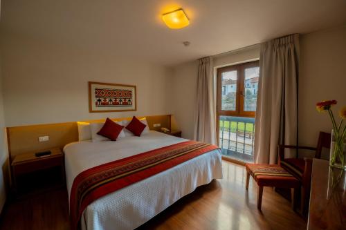 a hotel room with a bed and a window at San Agustin Plaza in Cusco
