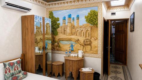 a bathroom with a painting on the wall at SILVER Inn in Bukhara