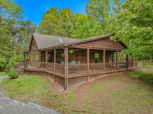a log home with a large porch and deck at Seventh Heaven - Hot Tub, Pet Friendly, Grill, Wifi, Deck, Covered Porch, Family Friendly, Kid's Loft, King Bed in Great Cacapon