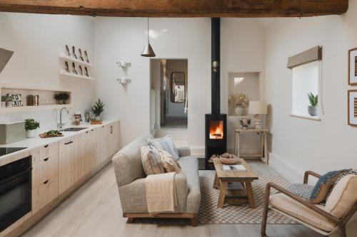 a living room with a couch and a chair and a table at Kennet in Marlborough
