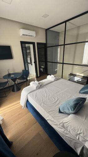 a bedroom with a large bed and a table at La Torre di LuSi in Castellammare di Stabia