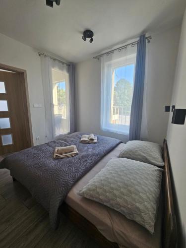 a bedroom with two beds and a window at Apartmány Koliba in Turčianske Teplice