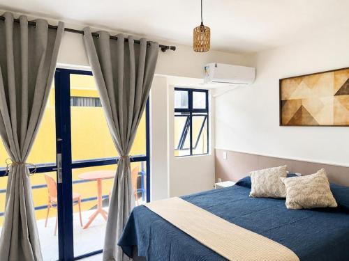 a bedroom with a blue bed and a window at Premium Apartment with Ocean View in Santiago