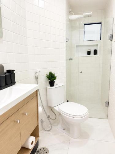 a white bathroom with a toilet and a shower at Premium Apartment with Ocean View in Santiago