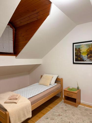 a bedroom with a bed and a table at Plavo oko in Sarajevo