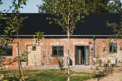 a brick house with a black roof at Ridgeway in Marlborough