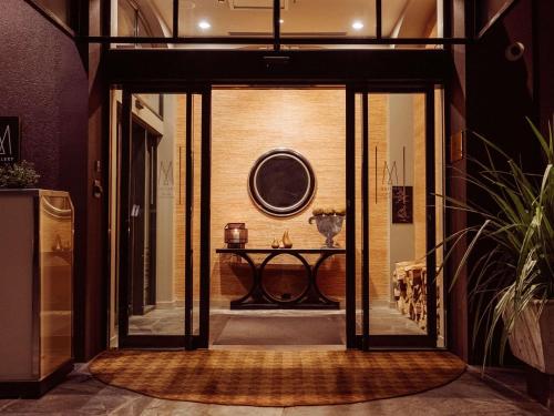 an open door to a room with a table at Hotel St Moritz, Queenstown - MGallery Collection in Queenstown