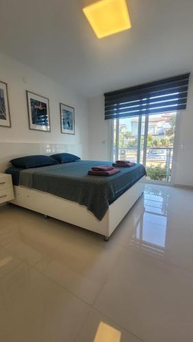 a bedroom with a bed and a large window at Urla Sea View House in Urla