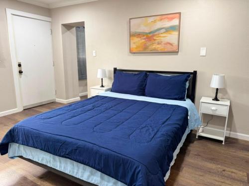a bedroom with a blue bed with two night stands at The Sandstone Suite in Cleveland