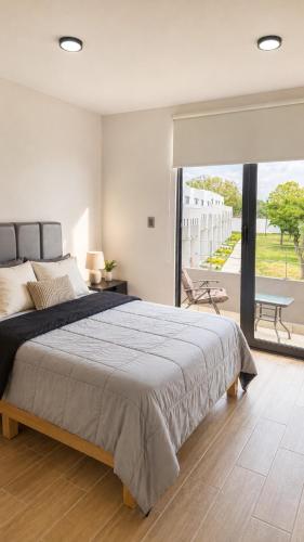 a bedroom with a large bed and a large window at Casa completa de fin de semana Cuautla in Tlayecac