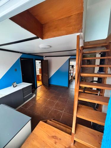 a view of a room with a wooden staircase at Raiza Hotel in Concepción
