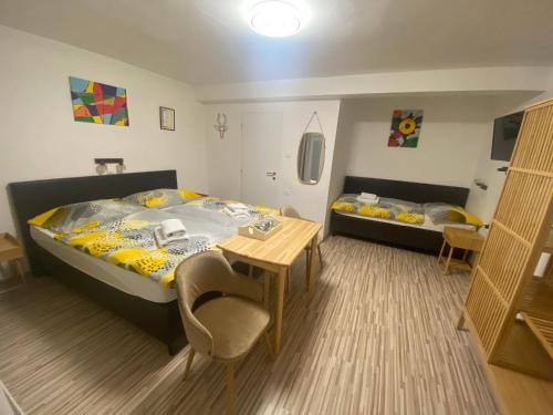a bedroom with two beds and a table and chairs at Penzión Oáza in Trnava