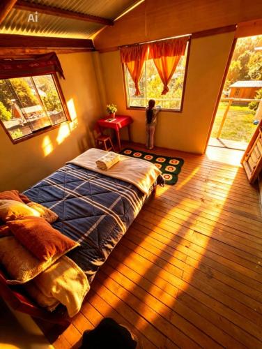 a bedroom with a bed in a room with a window at Salkantay Wasi in Colcapampa