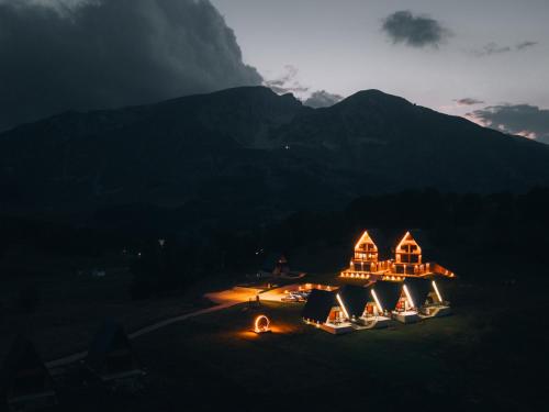 a group of tents with a mountain in the background at Monte zone Zabljak in Žabljak