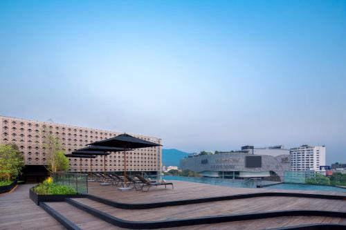 a view of a building with benches and buildings at U Nimman Chiang Mai in Chiang Mai