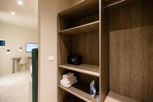 a room with a closet with wooden shelves at Otti Hotel in Vlorë