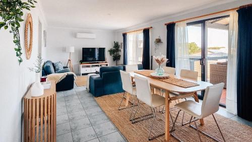 a living room with a table and chairs and a couch at Seascape Cottage on Kangaroo Island in Baudin Beach