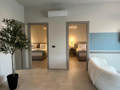a hotel room with two beds and a potted plant at Mirror Villas in Dhorizáta