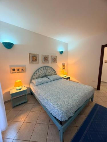 a bedroom with a bed with two tables and two lamps at La Terrazza sul Golfo in Golfo Aranci