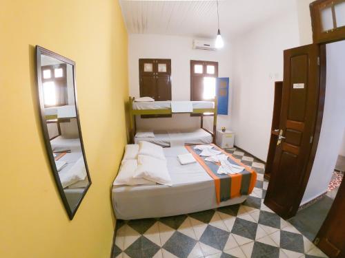 a bedroom with two bunk beds and a mirror at Pajuçara Inn - Pousada Maceió in Maceió