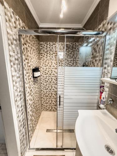 a bathroom with a shower and a toilet and a sink at Smile studio in Drama