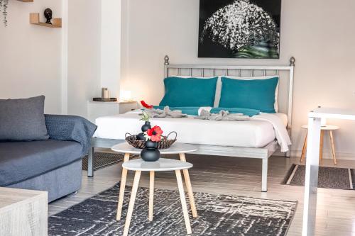 a bedroom with a bed with blue pillows and a table at Smile studio in Drama