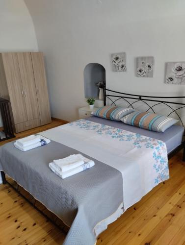 a bedroom with a bed with towels on it at Mastic lithos house in Chios